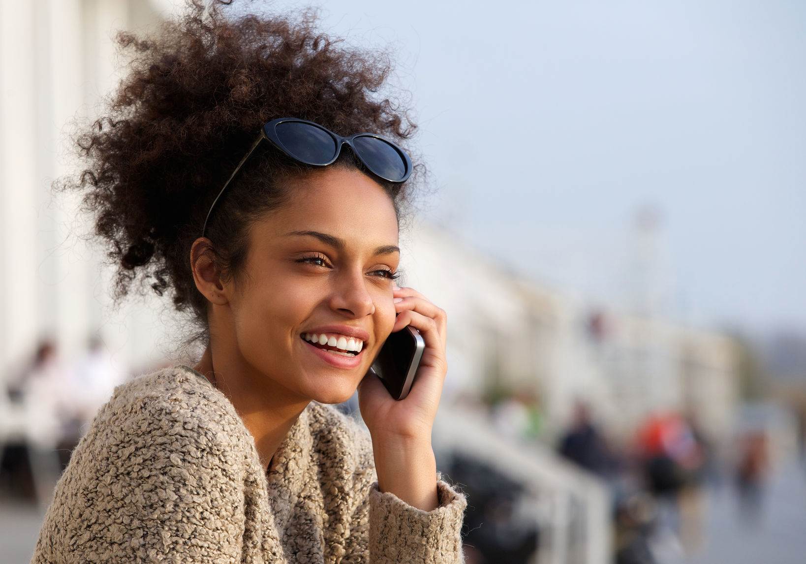 40345571 - close up portrait of an attractive young woman smiling and talking on mobile phone