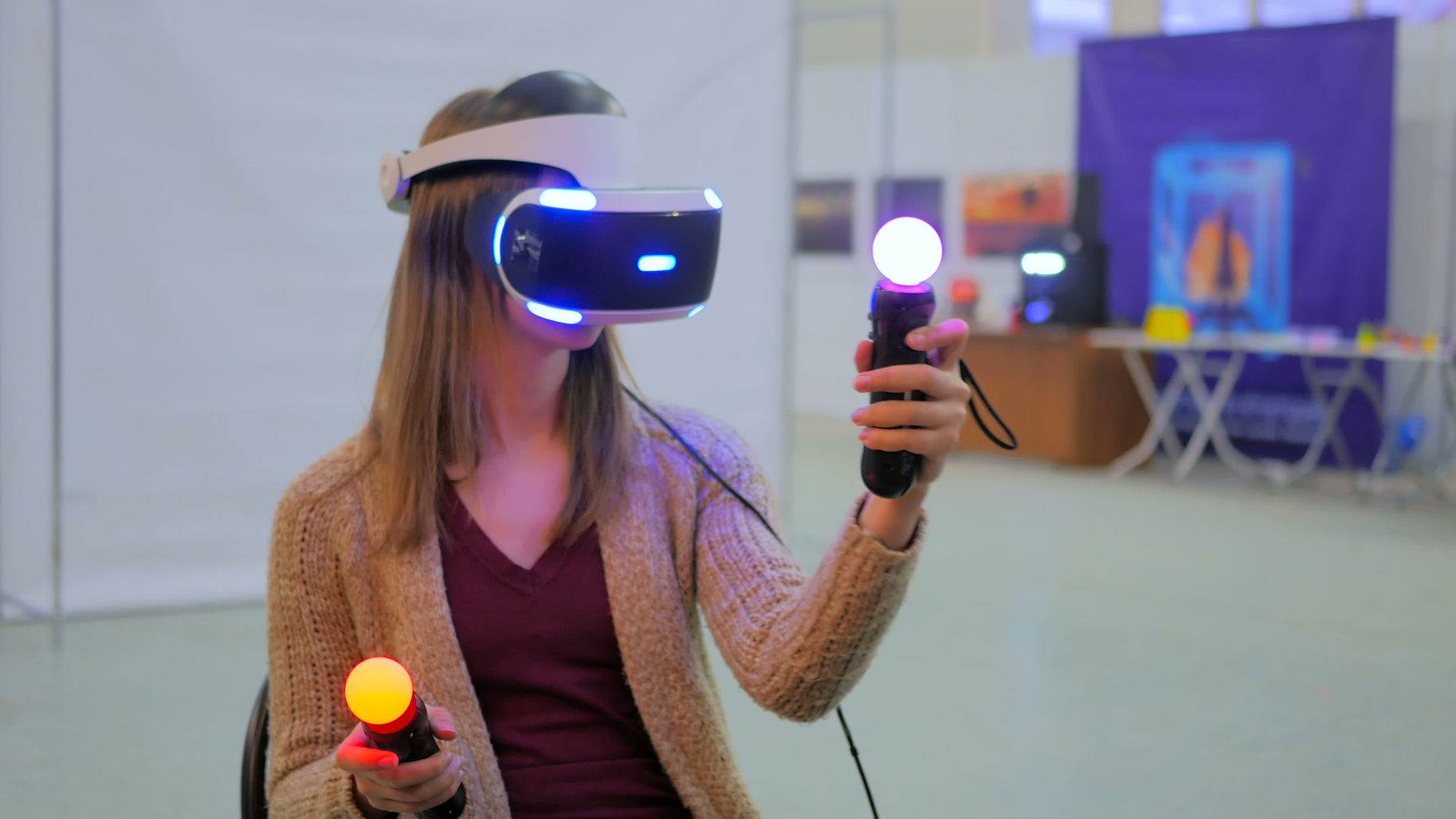75501873 - virtual reality game. young woman using virtual reality glasses and hand controlers
