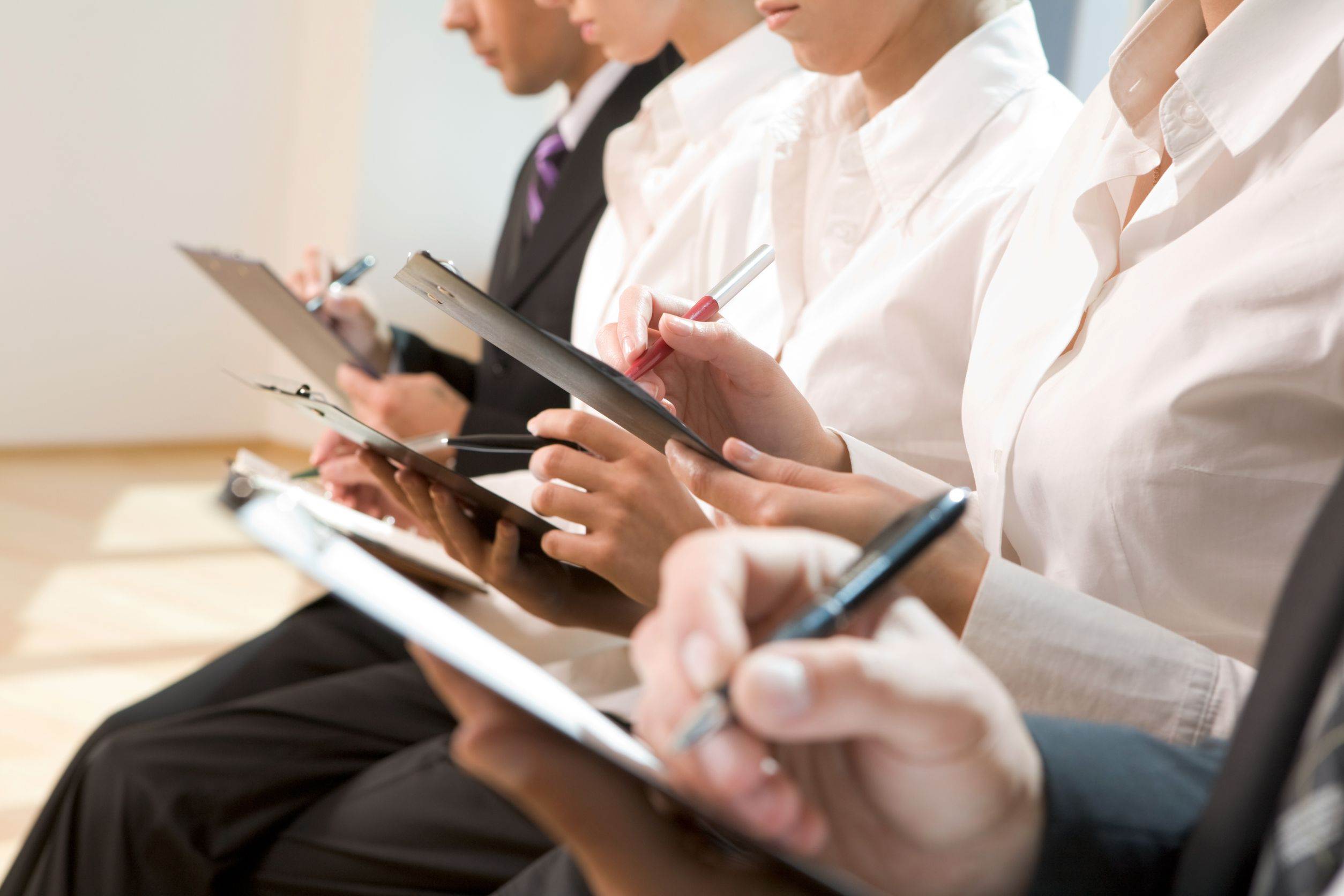 8474981 – image of row of business people writing on papers at seminar image of row of business people