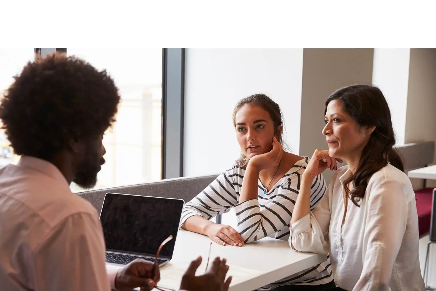 Three people in a conference.