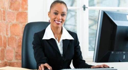 young business woman sitting at her desk