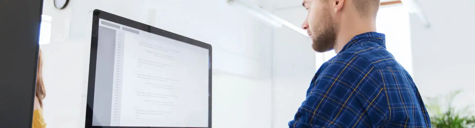 man working in front of a computer monitor