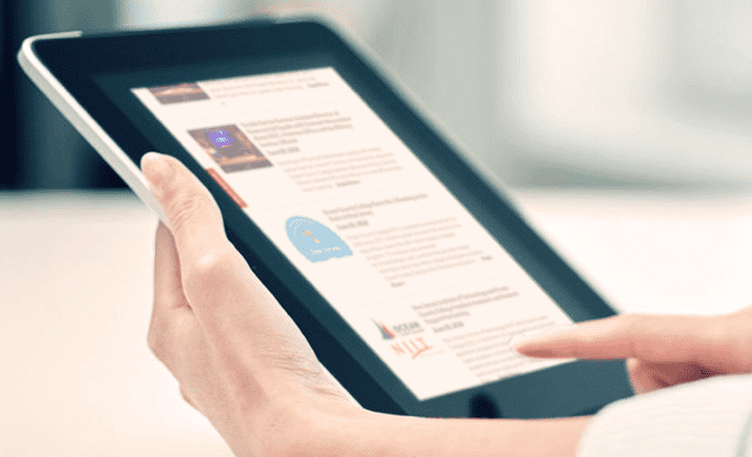 news_events a person using a tablet to read the news
