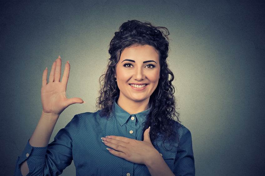 52658670 – young woman making a promise ASL - American Sign Language