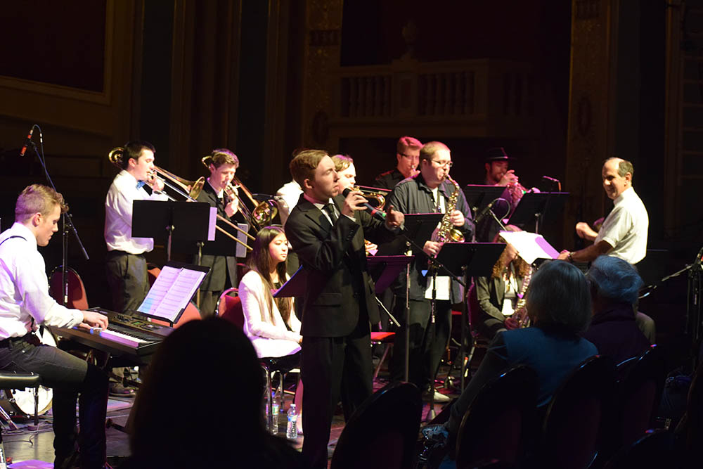 Singer with trombones supporting