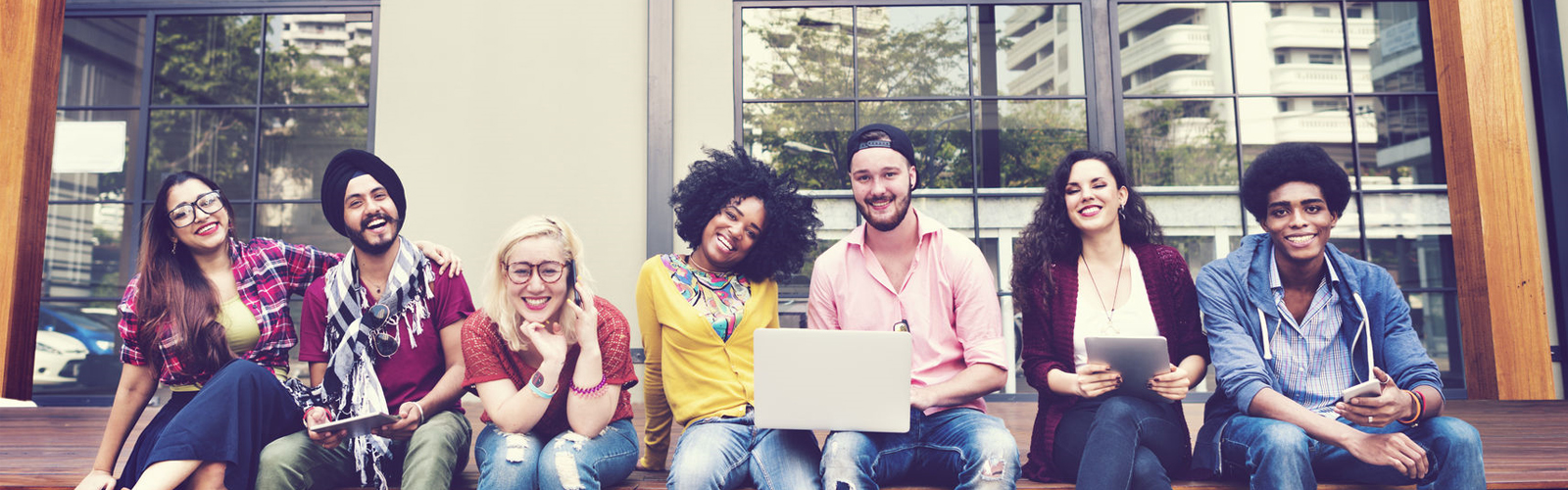 group of diverse students sitting outside