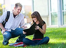 Students Sitting on lawn studying