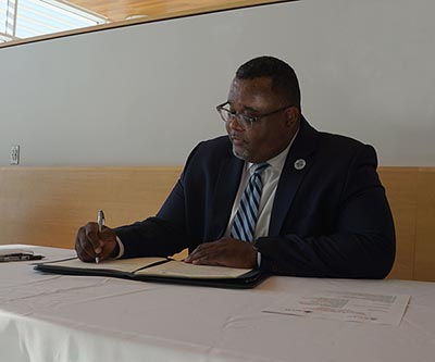 Kean University President, Lamont O. Repollet, Ed.D. signing a partnership agreement between OCC and Kean University