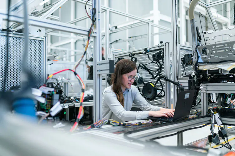 engineer working on a laptop inside a laboratory