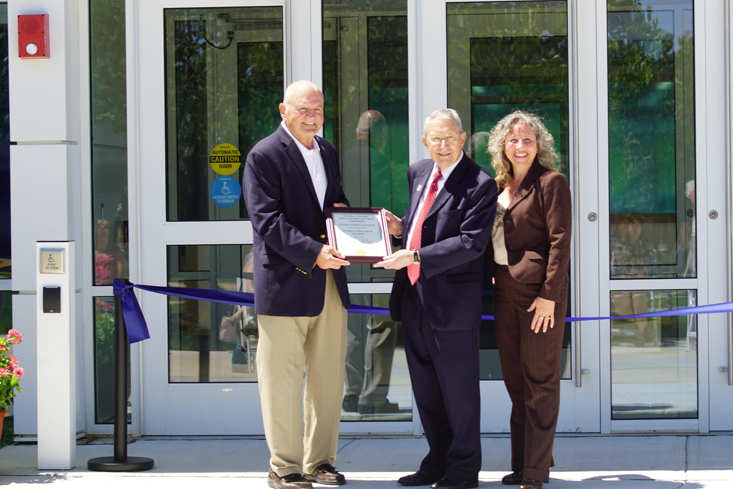 Dr. Jon H. Larson, OCC’s president, center, poses with a plaque commemorating the establishment of the new building from the Mayor of Toms River, Maurice B. Hill. Dr. Larson is joined by Mayor Hill and Toms River Councilwoman Laurie Huryk.