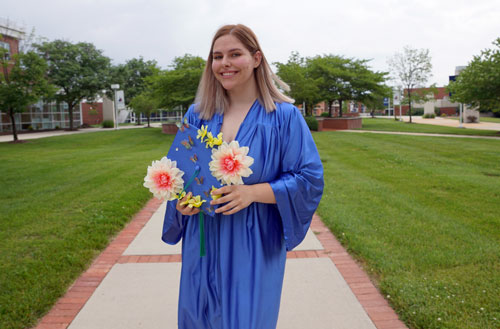 student posing with their decorated cap at the Ocean County Achievement center graduation