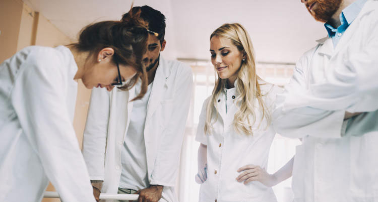 group of medical students practicing reanimation task on model