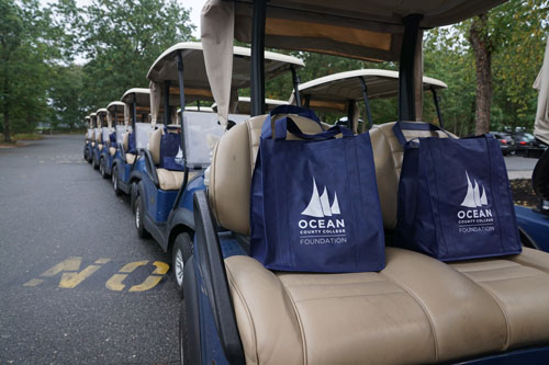 golf carts with O.C.C. foundation blue bags at the Golf classic
