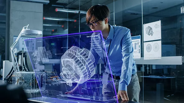 Young adult in the workplace standing in front of a visualization of a gear