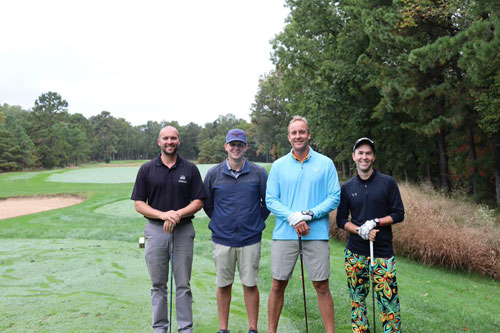group of four men at the 20th annual foundation golf classic