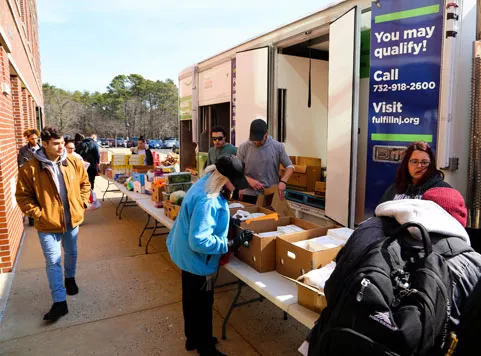 Helping hands food pantry and Fulfill food bank giving food donations to students