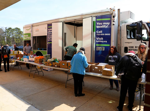 Helping hands food pantry and Fulfill food bank setting up food donations to students from the fulfill truck