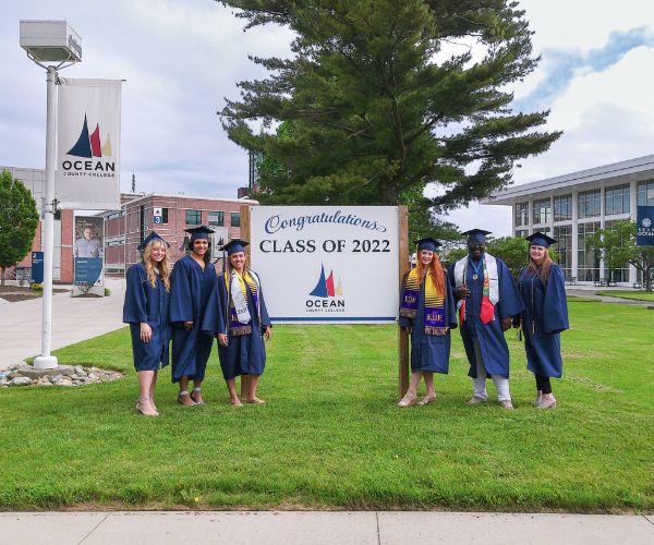 EOF Graduation Photo 2 EOF Students Standing in front of the Graduation Sign