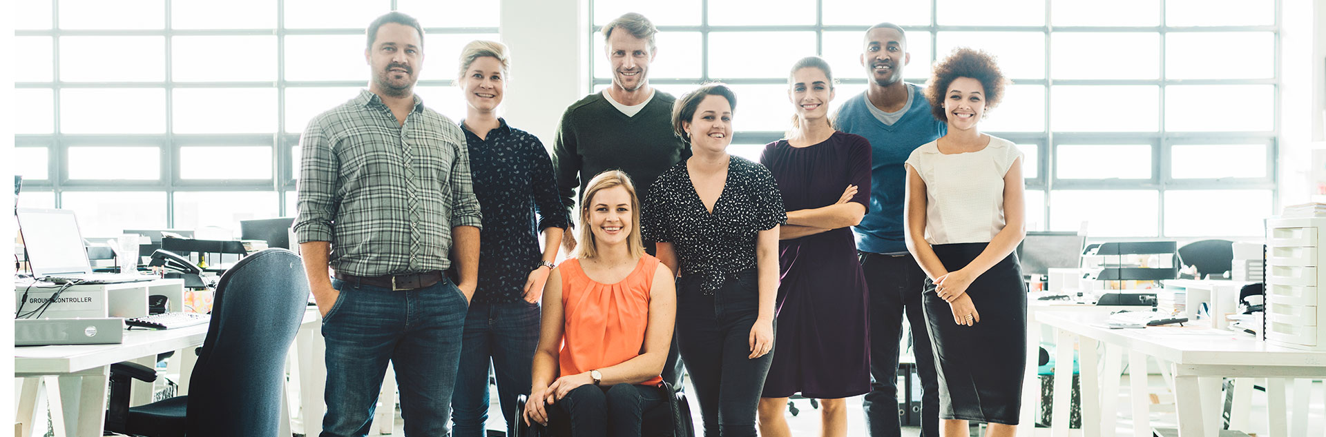 Diverse business people smiling in creative office.