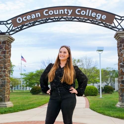 Hailey Sadowski standing under OCC's Archway