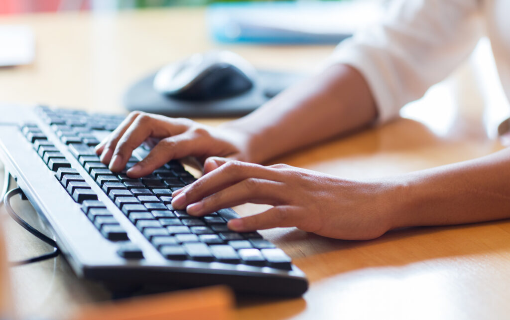 Agile Individual typing on the keyboard at office