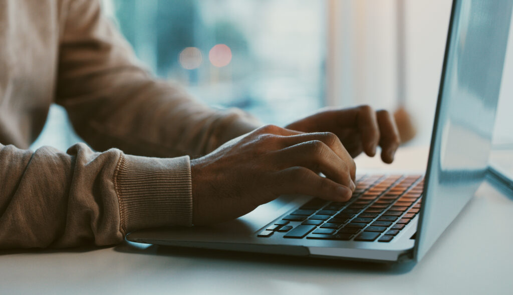 Comp TIA A+ Person typign on their laptop keyboard