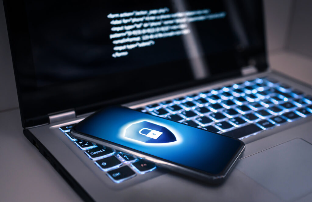 Security+ Certification locked phone laying on top of a laptop