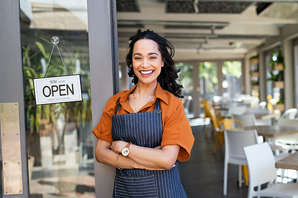 small business owner standing at cafe entrance