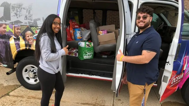 Two people unloading truck