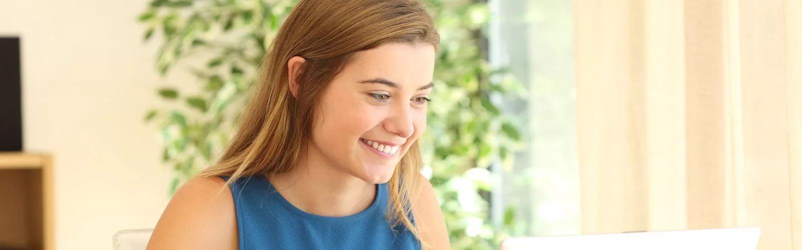 girl smiling in front of window