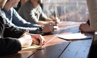 people writing on desk