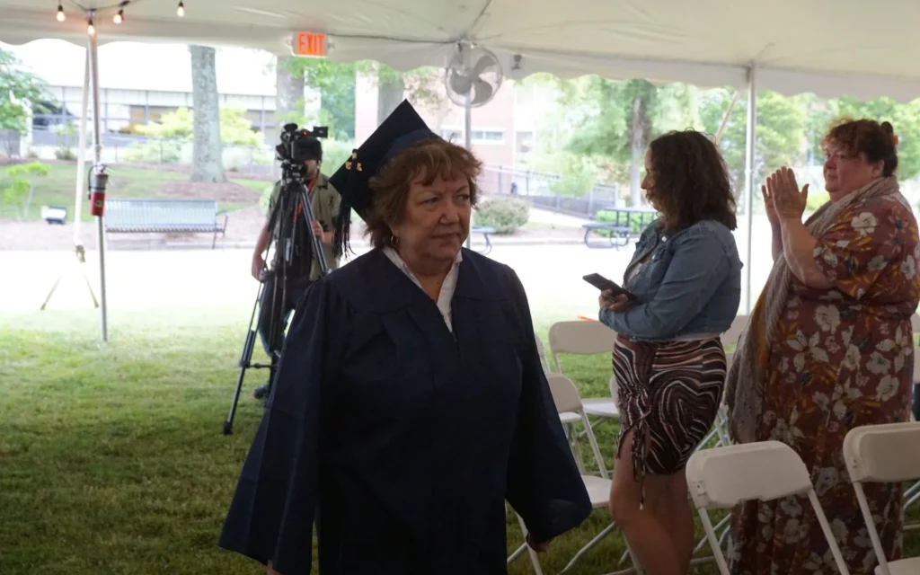 Female student in cap and gown at graduation