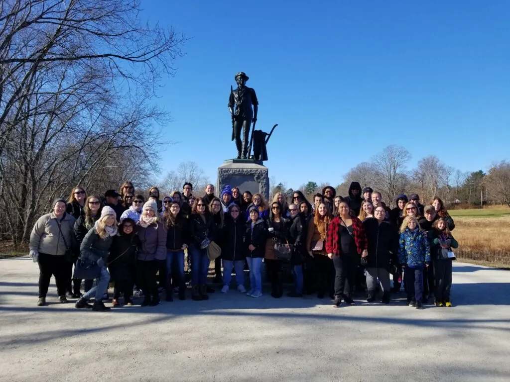 occ students standing in front of the monument
