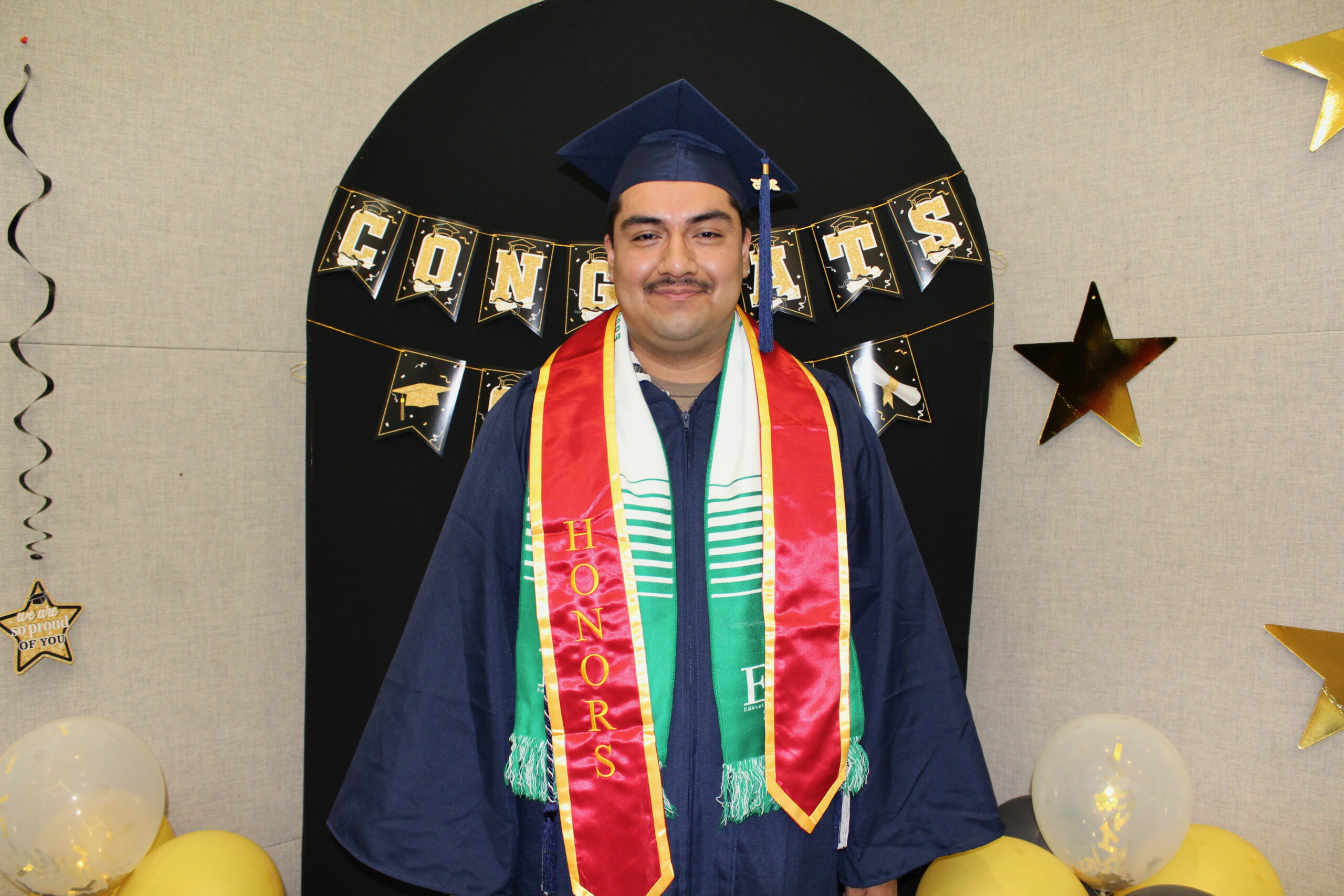 a student posing in graduation regalia