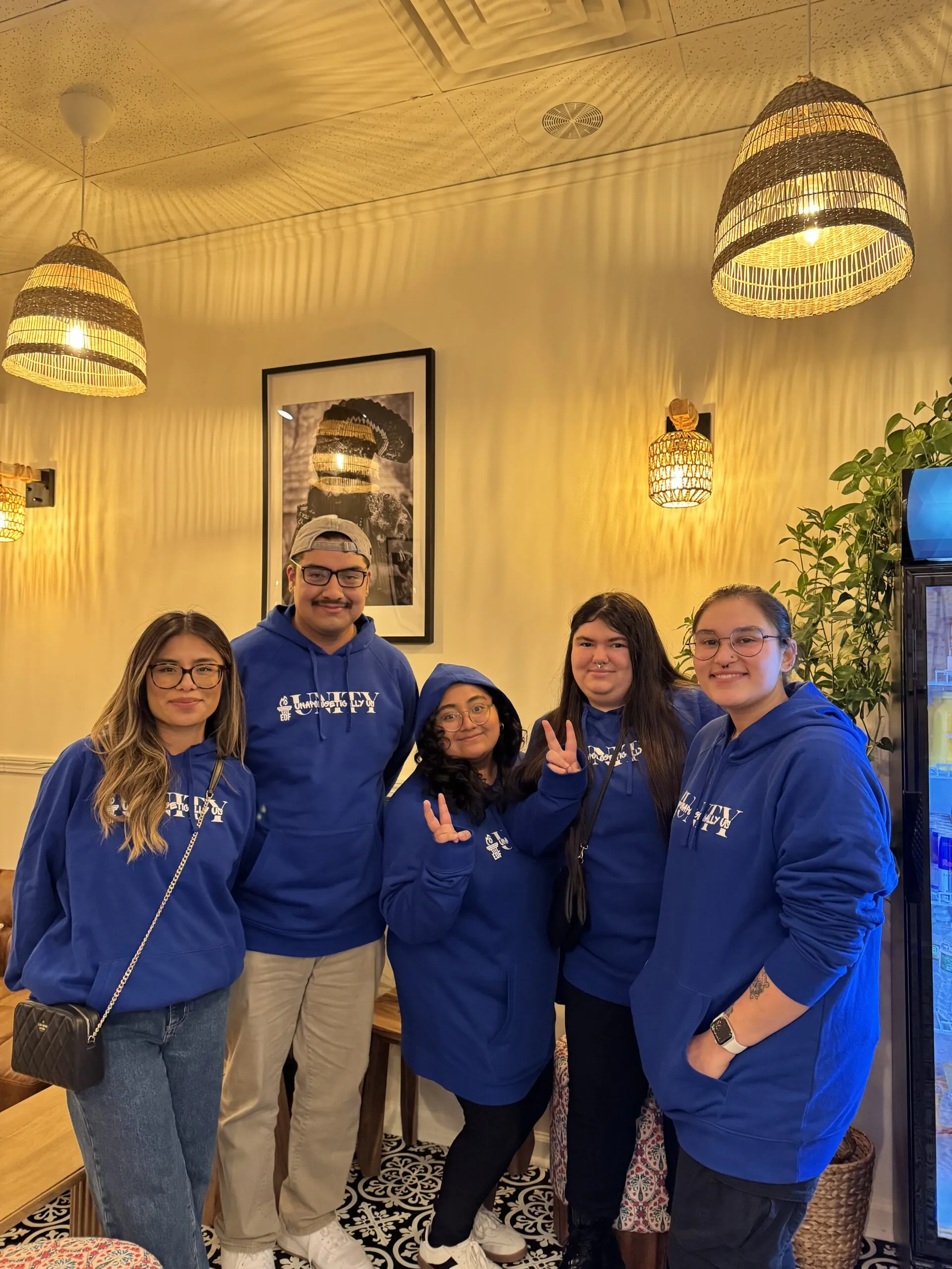 Group of EOF students posing in matching sweatshirts at a conference