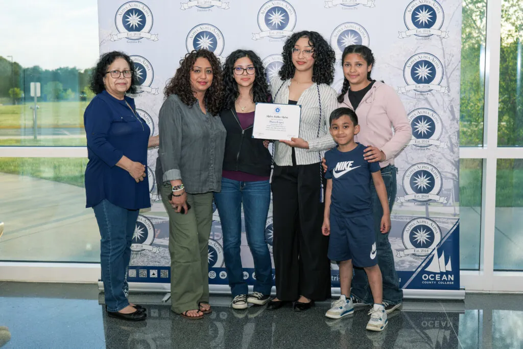 Family posing in front of a backdrop