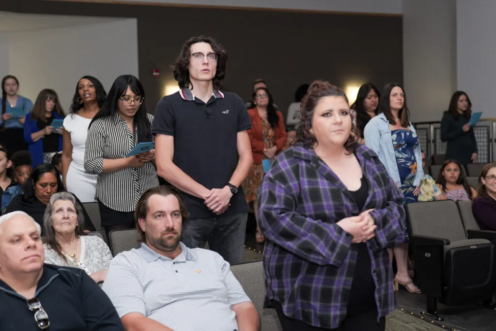 students standing up to recite the membership pledge