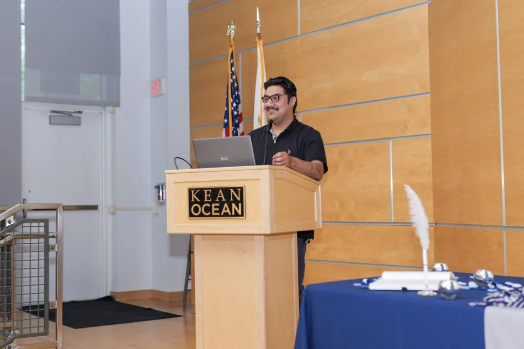 Student speaker, Marco Ruiz, standing at a podium on stage