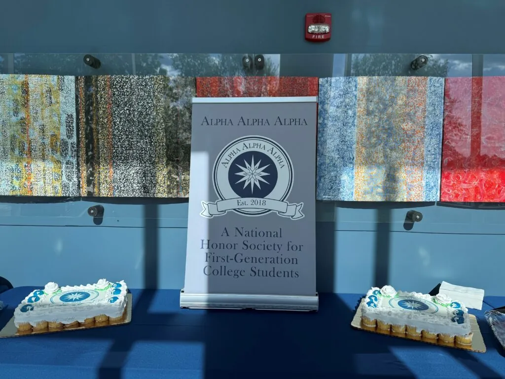 table displaying banner and cupcakes with Tri-Alpha logo