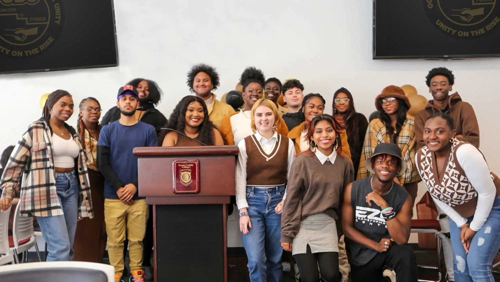Students gathered around a podium
