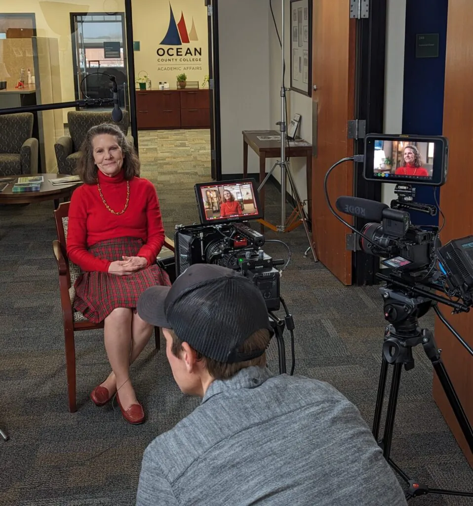 OCC President sitting in front of video cameras waiting to be interviewed