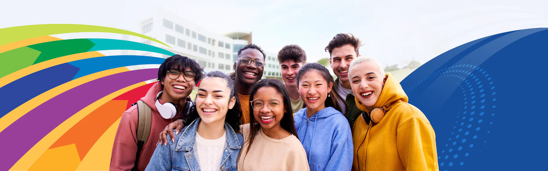 Students smiling in from of the Gateway Building with colorful design elements