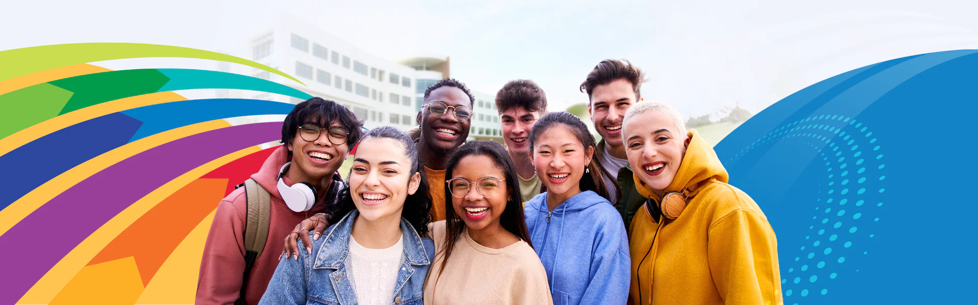 Students smiling in from of the Gateway Building with colorful design elements