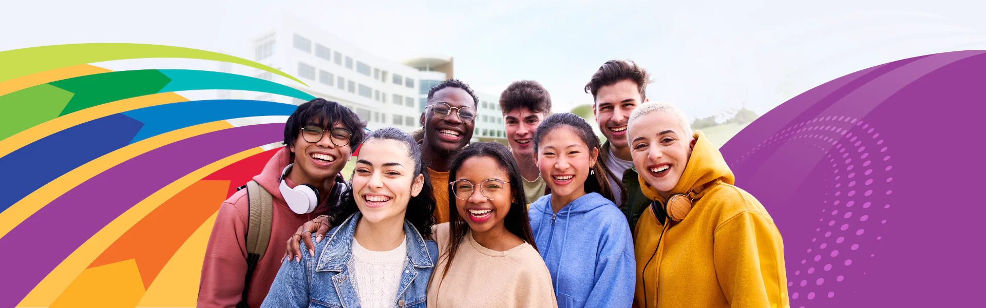Students smiling in from of the Gateway Building with colorful design elements