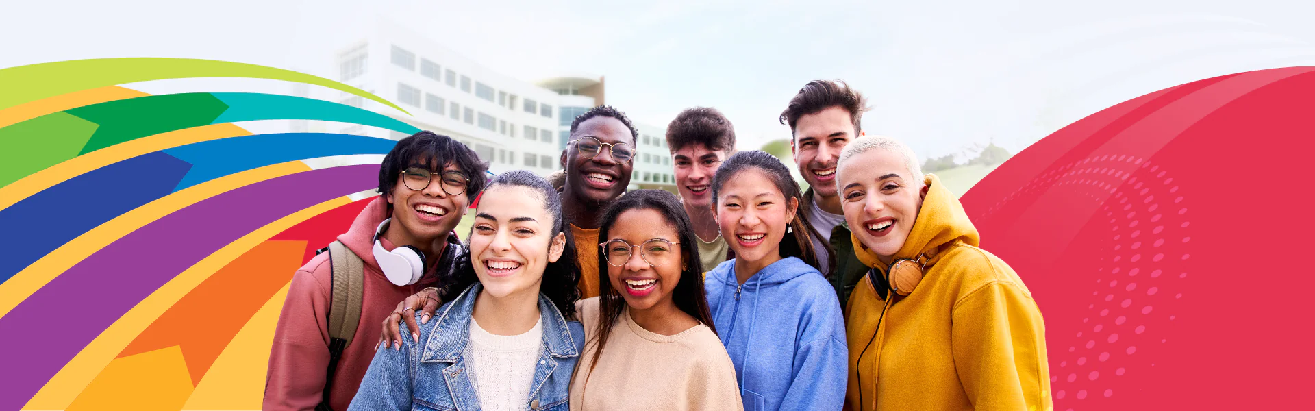 Students smiling in from of the Gateway Building with colorful design elements