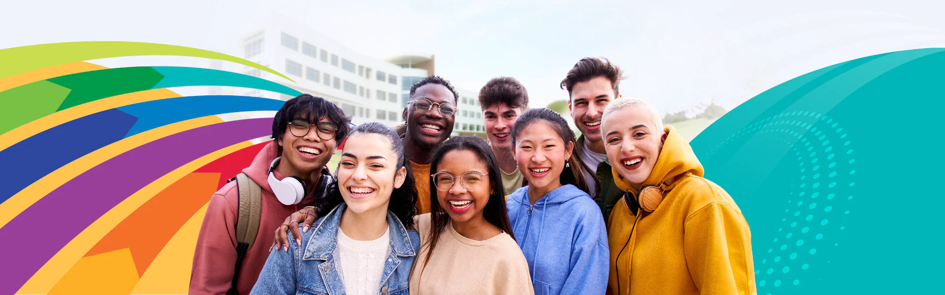 Students smiling in from of the Gateway Building with colorful design elements