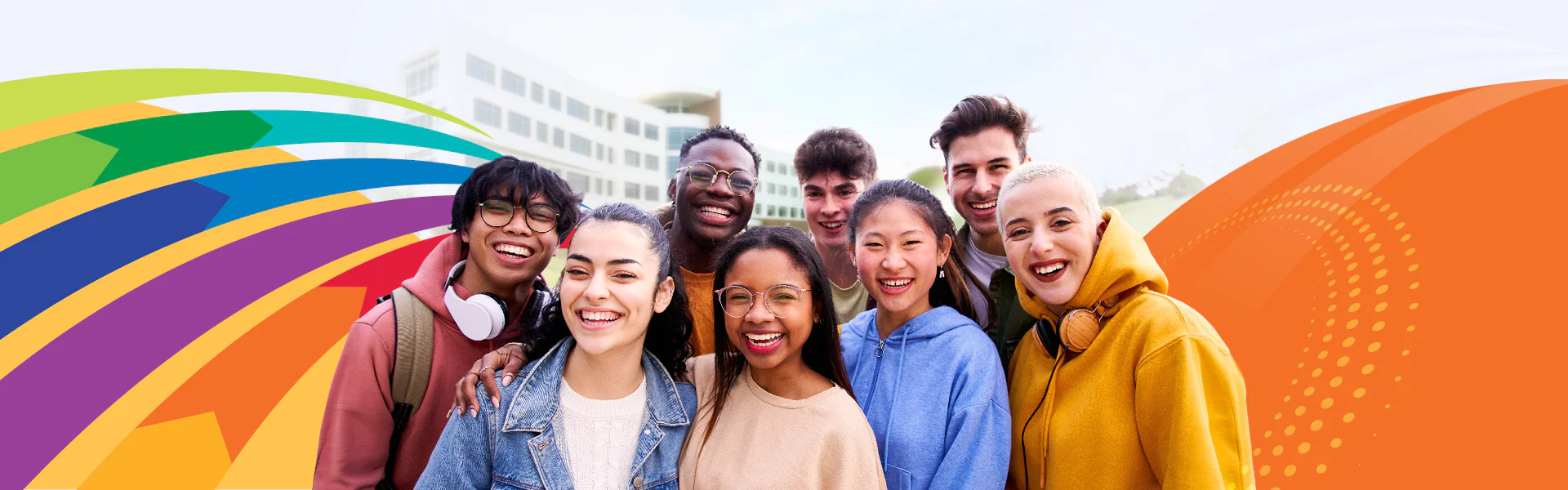Students smiling in from of the Gateway Building with colorful design elements