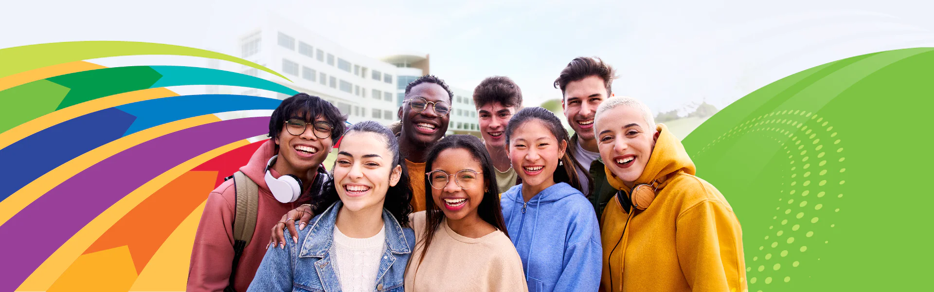 Students smiling in from of the Gateway Building with colorful design elements
