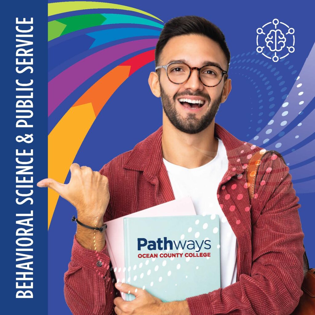 Behavioral Science with a student holding a book that hasOcean County College pathways written on the front