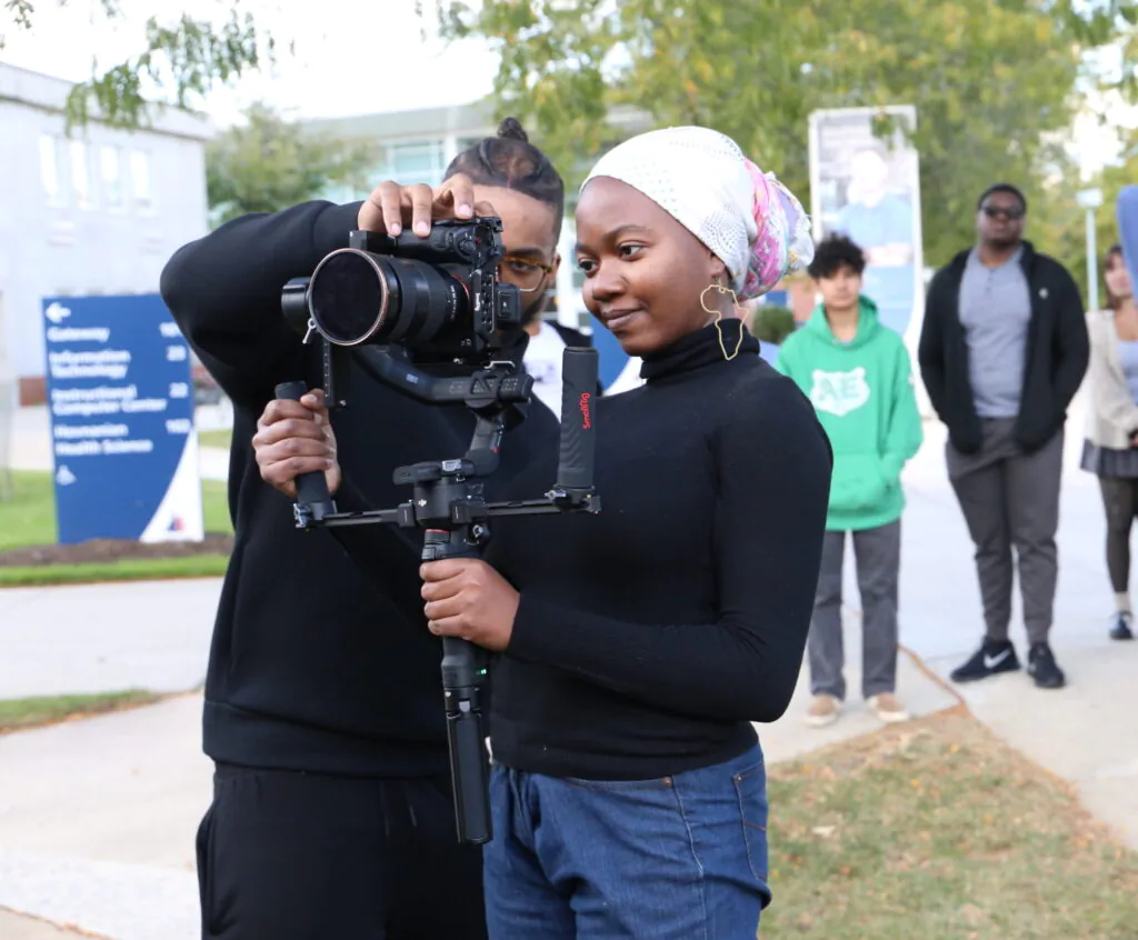 Students behind video camera with others watching